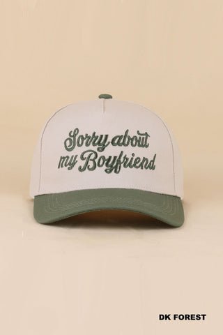 Cap with 'Sorry about my boyfriend' text on a beige background