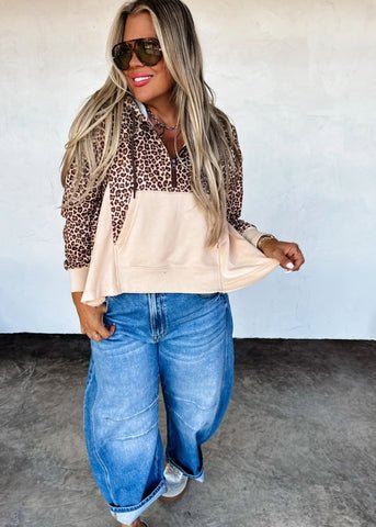 cheeta half zip pull over with off white bell around the bottom of the pull over.
